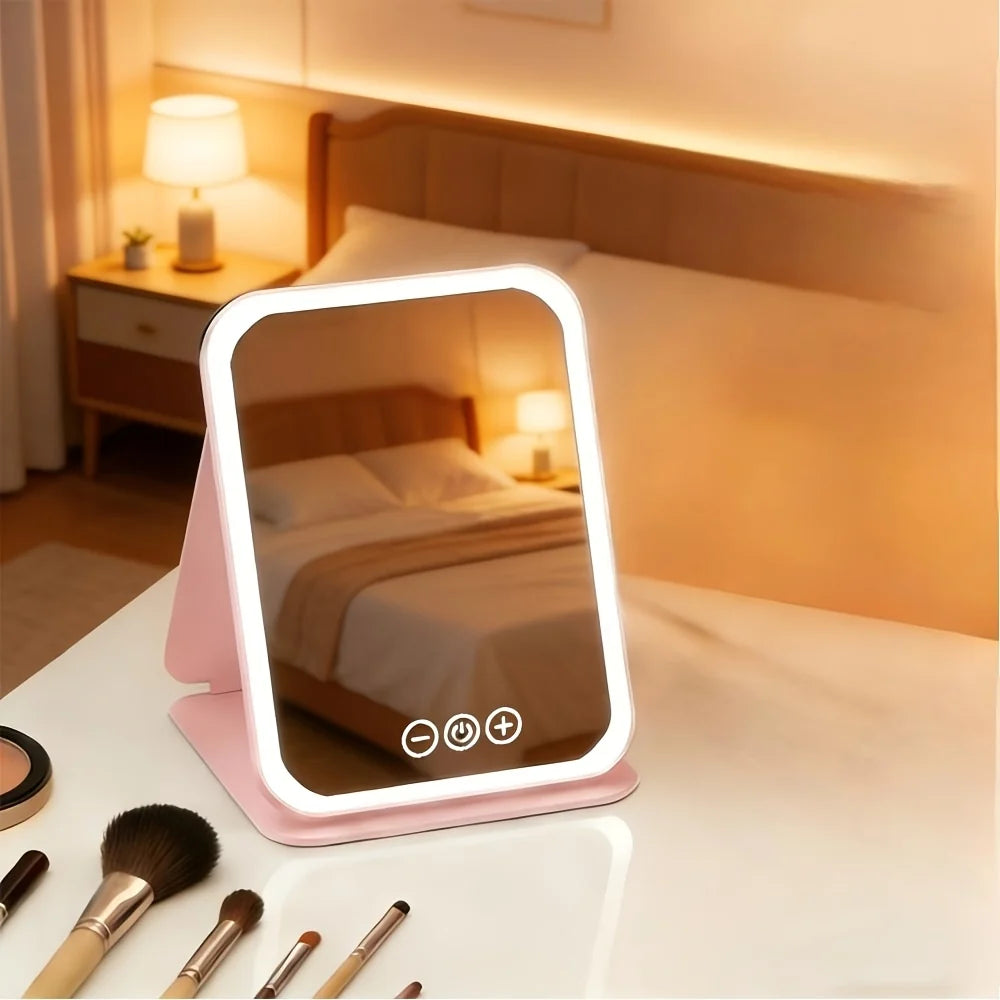 Espejo tocador con luz táctil, plegable y portátil, de diseño moderno en plástico rosa, ideal para maquillaje y cuidado personal. 3