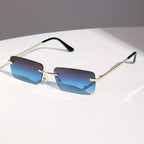 Gafas de sol sin montura con protección UV, marco metálico ligero y diseño moderno unisex, ideales para cualquier ocasión. 1