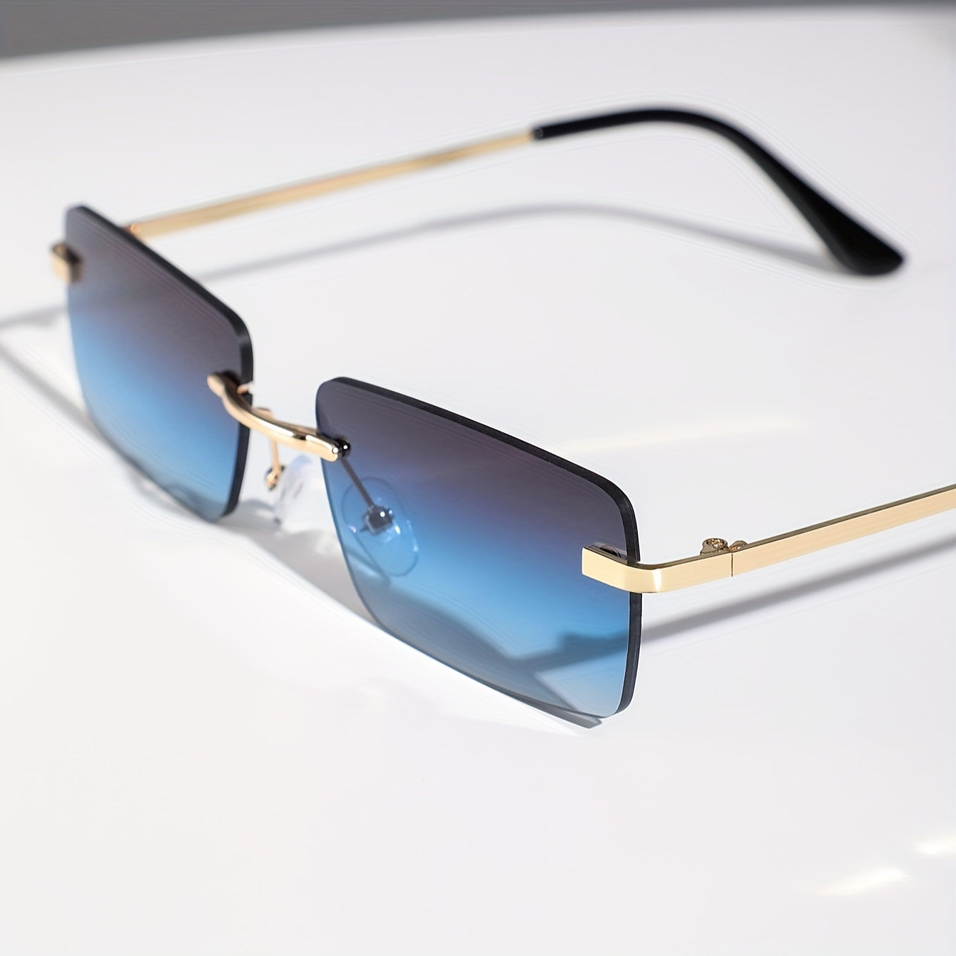 Gafas de sol sin montura con protección UV, marco metálico ligero y diseño moderno unisex, ideales para cualquier ocasión. 2