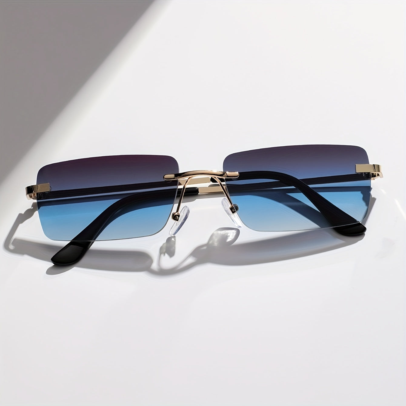 Gafas de sol sin montura con protección UV, marco metálico ligero y diseño moderno unisex, ideales para cualquier ocasión. 3