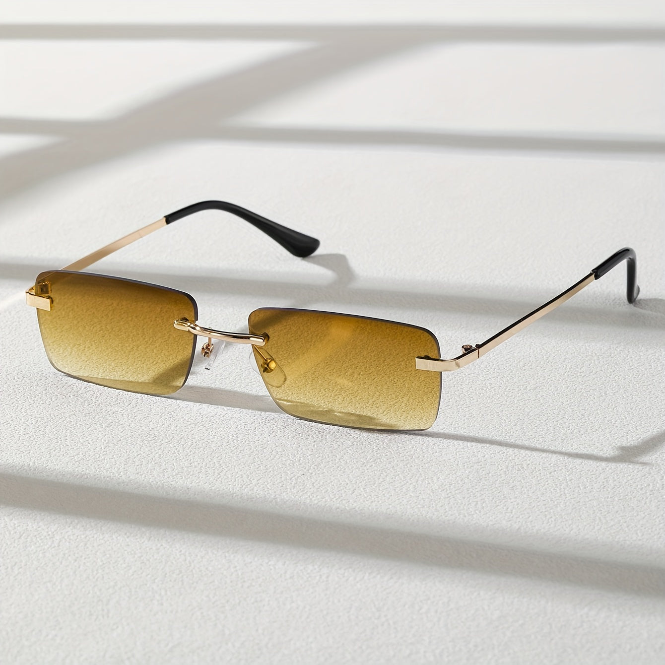 Gafas de sol sin montura con protección UV, marco metálico ligero y diseño moderno unisex, ideales para cualquier ocasión. 5