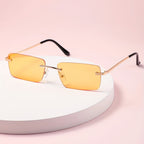 Gafas de sol sin montura con protección UV, marco metálico ligero y diseño moderno unisex, ideales para cualquier ocasión. 6