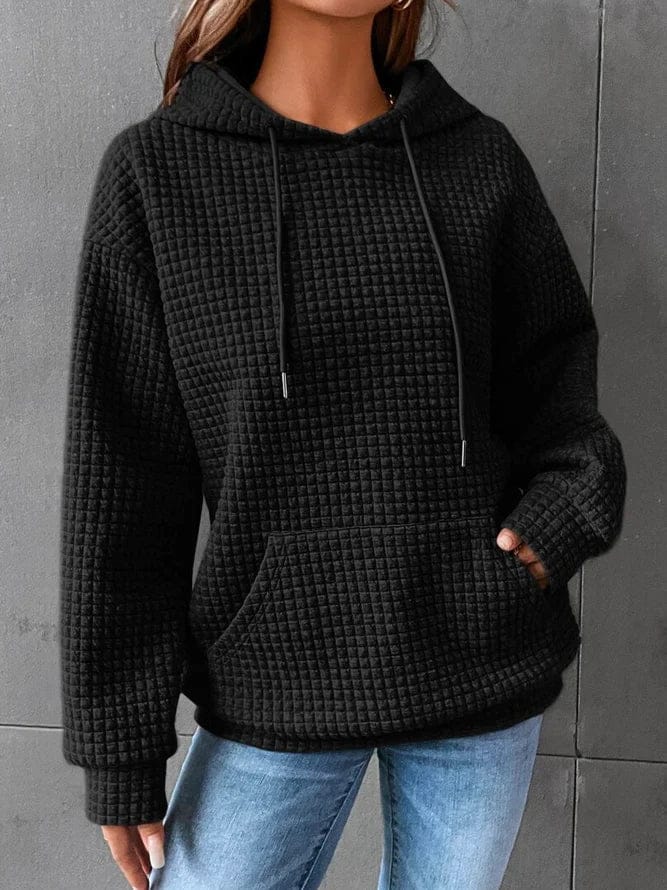 Sudadera mujer negra con capucha ajustable y bolsillo canguro, corte relajado en punto gofrado texturizado. 0