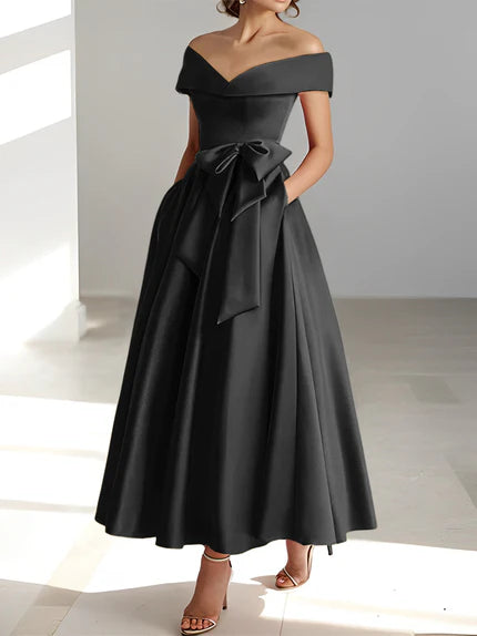 Vestido de madrina de boda en satén fucsia, largo al tobillo, con hombros descubiertos y prácticos bolsillos. 2